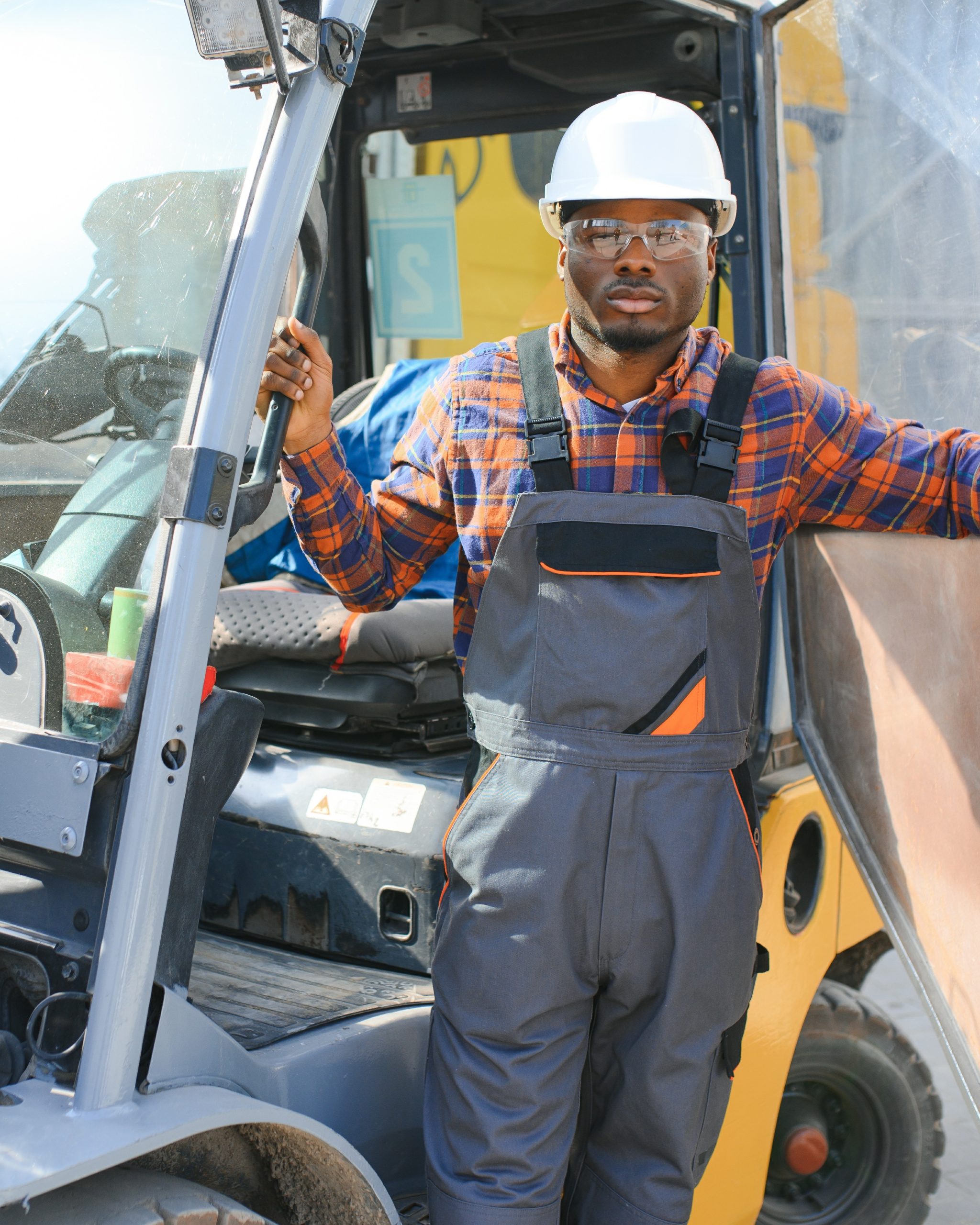 African American Man at work. Professional operation engineering. Young worker forklift driver.